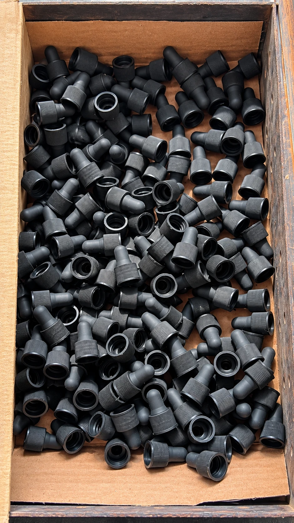 Black dropper nipples fitted into ribbed polypropylene caps